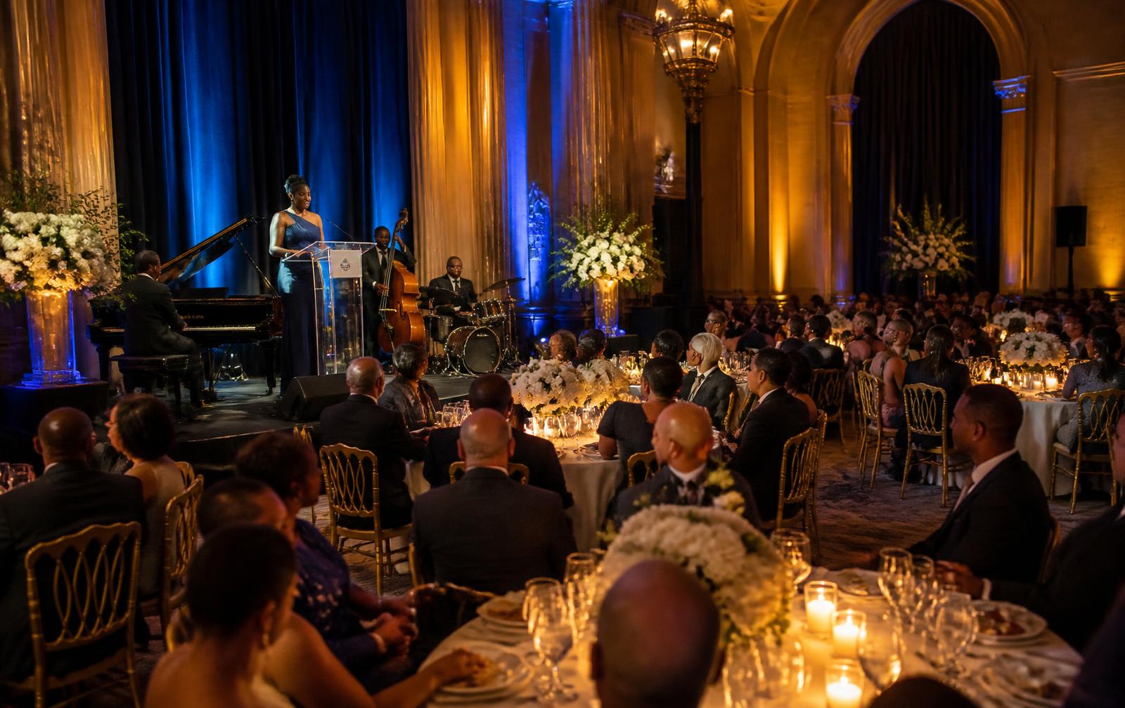 Aspirational scene of an elegant evening awards gala with well-dressed guests at banquet tables